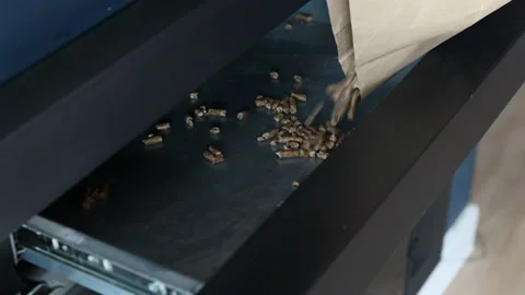 Man's hand pouring a sack of pellets into a chimney. Energy saving concept. Stock Footage 220013196