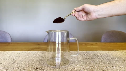 Man’s Hand Pours Coffee Grounds into Glass Scandinavian French Press with Spoon Video stock 249122920