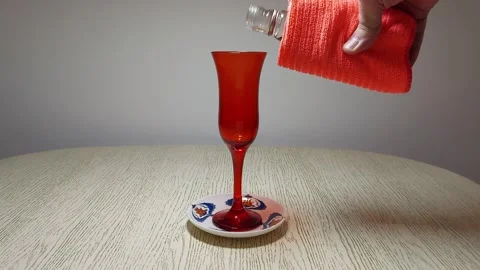 A mans hand pours into a glass 스톡 동영상 303975341