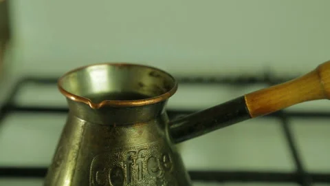 A man's hand pours ground coffee in a Turk. Close-up 库存影片 101496299