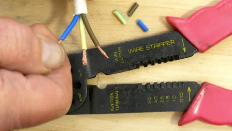 Man’s hand preparing trimmed cable wires next to a cutter tool. Video stock 221279970