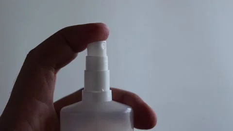 Man's hand presses the button of a sprayer Stock Footage 133659059