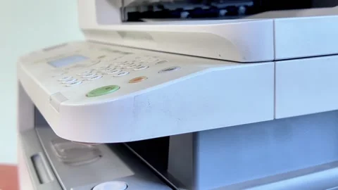 A man's hand presses a green button on the front panel and the MFP starts c.. Stock Footage 317453470