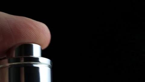 The man's hand presses on the perfume diffuser on a black background. Copy space Vidéo 157050641