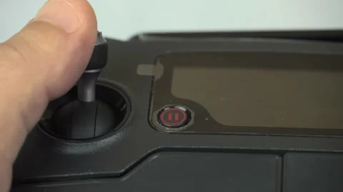 A man's hand presses the remote control stick of the drone. Vidéo 141855816