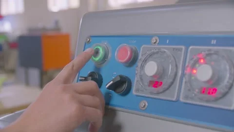 Man's hand presses start button on the control panel of dough machine in the Stock Footage 204855235