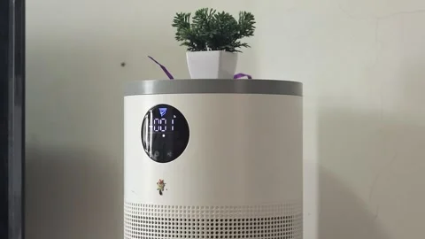 A man's hand pressing button on air purifier at home. Turn on the air purifie Stock Footage 328928584