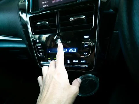 Man's hand pressing a button (Emergency lighting system), car interior. Stock Photos