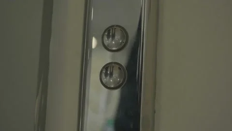 Mans hand pressing elevator down button. HDR. Close up of male finger getting Stock Footage 165240460