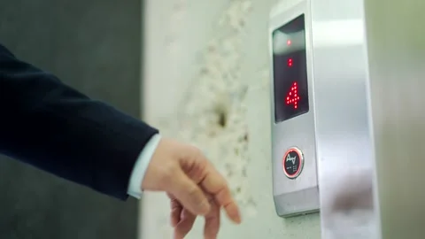 Mans hand pressing elevator down button. Close up of male finger getting  Stock Footage 240557138