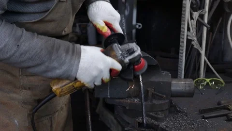 Man’s hand in protective gloves handles an iron product secured in a slow motion Stock Footage 120112791