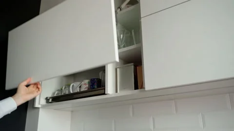 Man's hand pulling and closing a drawer at modern white kitchen Stock Footage 153289119