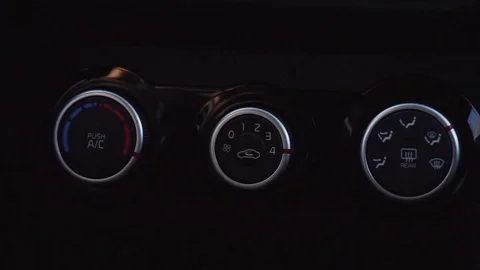 Man's hand push the button that switches the air conditioning in the car. Stock Footage 73446339
