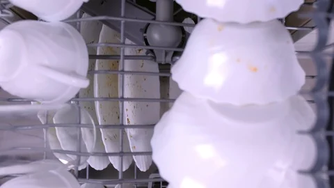 Man's hand pushes dishwasher baskets with dirty dishes. Stock Footage 106293768