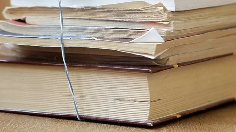 Man's hand pushes a stack of books, and puts on the plate shelf Stock Footage 102673813