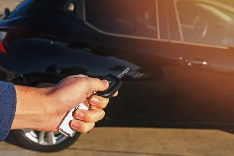 Man's hand pushing button on remote control car key Stock Photos