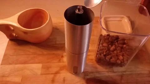 Man's hand put coffee beans into a coffee grinder Stock Footage 340357407