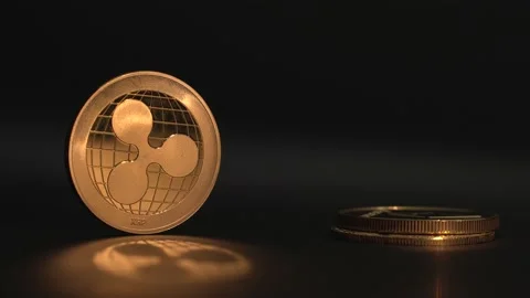 Man's hand put crypto coins one on top of the another. Golden ripple coin XRP Stock Footage 129823709