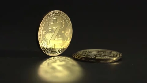 Man's hand put crypto coins one on top of the another. Golden Zcash ZEC coin Stock Footage 129823815