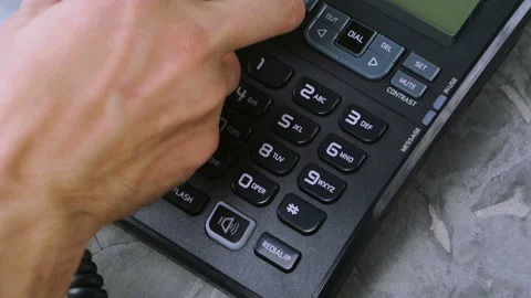 Man's hand put handset on black telephone on concrete surface Stock Footage 91703185