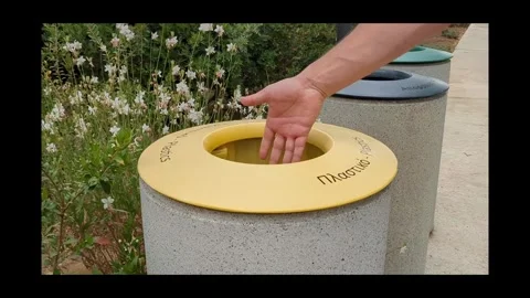 Mans hand put plastic cocktail tube to the trash can. Waste sorting. Stock Footage 310083442