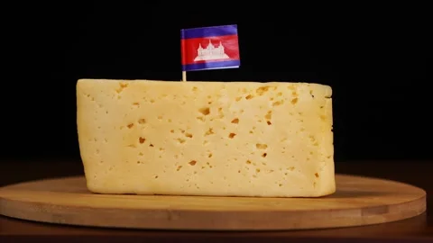 Man's hand put small in size toothpick with cambodian flag on cheese. Stock Footage 159816722