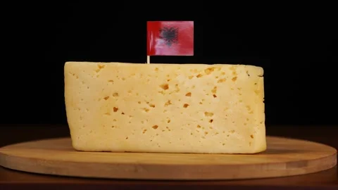 Man's hand put small in size toothpick with Albanian flag on cheese. Stock Footage 159817262