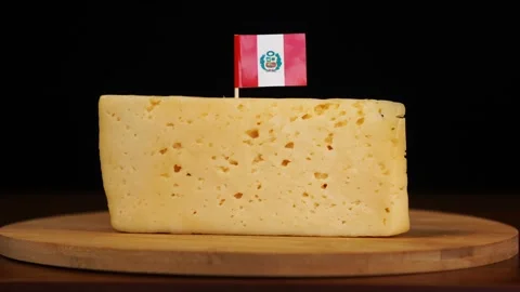 Man's hand put small in size toothpick with peruvian flag on cheese. Stock Footage 159818858