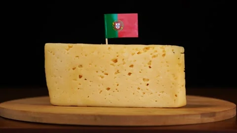 Man's hand put small in size toothpick with portuguese flag on cheese. Stock Footage 159820935