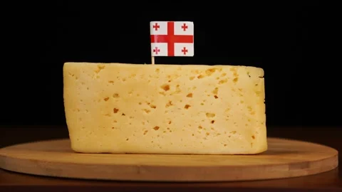 Man's hand put small in size toothpick with georgian flag on cheese. Stock Footage 159822823