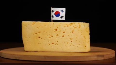 Man's hand put small in size toothpick with korean flag on cheese. Stock Footage 159822980