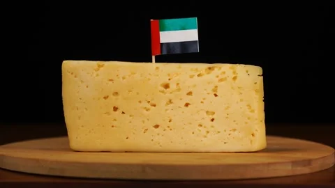 Man's hand put small in size toothpick with UAE flag on cheese. Stock Footage 159825314