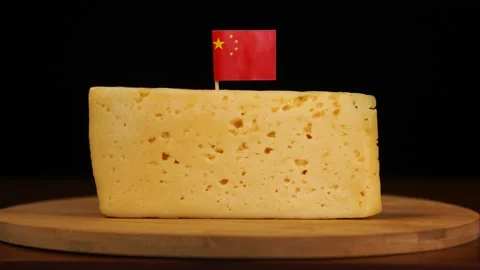 Man's hand put small in size toothpick with chinese flag on cheese. Stock Footage 159826206