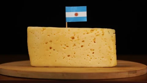 Man's hand put small in size toothpick with argentinian flag on cheese. Stock Footage 159826330