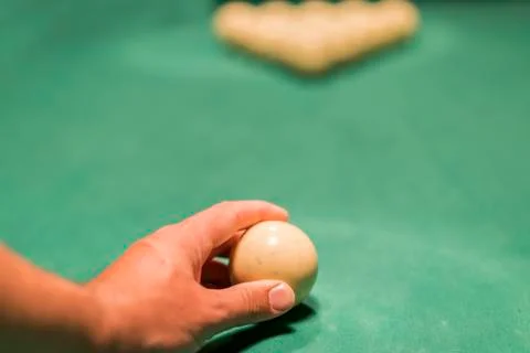 A man's hand puting a billiard ball. Preparation for the decisive blow Stock Photos