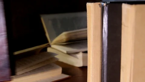 A man's hand puts the book on a shelf Stock Footage 84225350