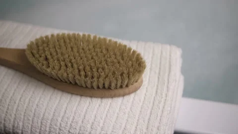 A man's hand puts a brush on a towel in the bathroom. A black razor. A white tow Stock Footage 147038121