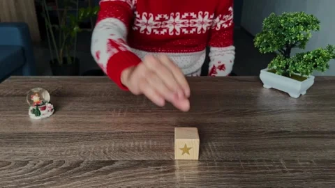 The man's hand puts the cubes in a horizontal row giving a rating of 5 stars Stock Footage 254334878