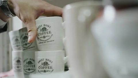 A man's hand puts the cup on the shelf Video stock 171412716