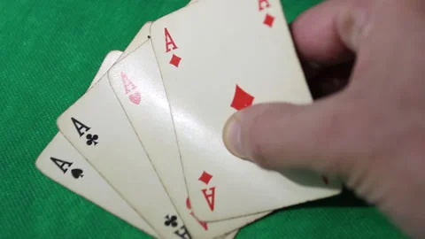 A man's hand puts his four aces on the green table while playing poker. Stock Footage 140208329