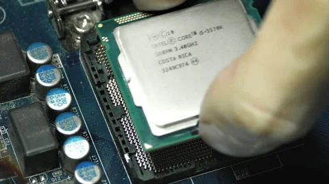Man's Hand Puts Intel I5 Processor Into Motherboard Socket and Then Removes It Stock Footage 58487912