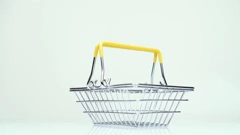 Man's hand puts one dollar in a supermarket basket Stock Footage 124411403
