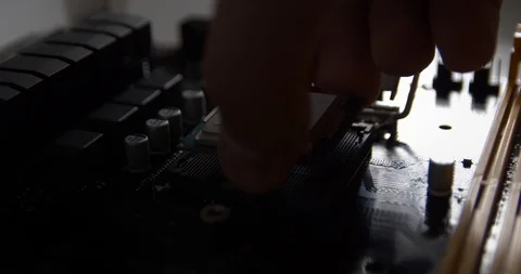 Man's hand puts the processor into the motherboard socket Stock Footage 88424765