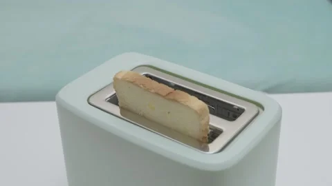 Man's hand puts slices in toaster Stock Footage 264092249