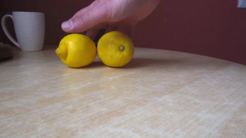 Man's hand puts two lemons on the table   SM Stock Footage 196170561