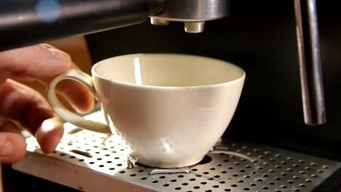 A man's hand puts a white cup in a coffee machine Stock Footage 83273916