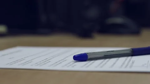Man's hand putting assigned contract and pen down to a desk. Stock Footage 43087934