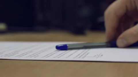Man's hand putting down a pen on the top of the assigned contract. Stock Footage 43088267