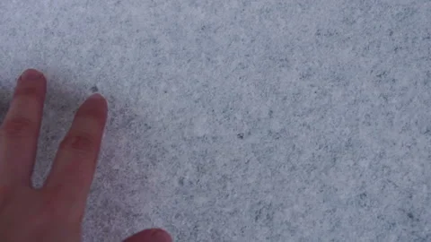 Man's hand rakes the snow from the blue surface. Slow motion Stock Footage 85761353