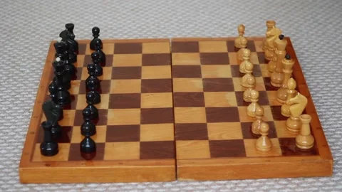 A man's hand rearranges a pawn on a chessboard Stock Footage 85692203